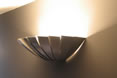 Uplighting is another option for increasing the perceived volume of a space. These design uplight sconces give indirect lighting.